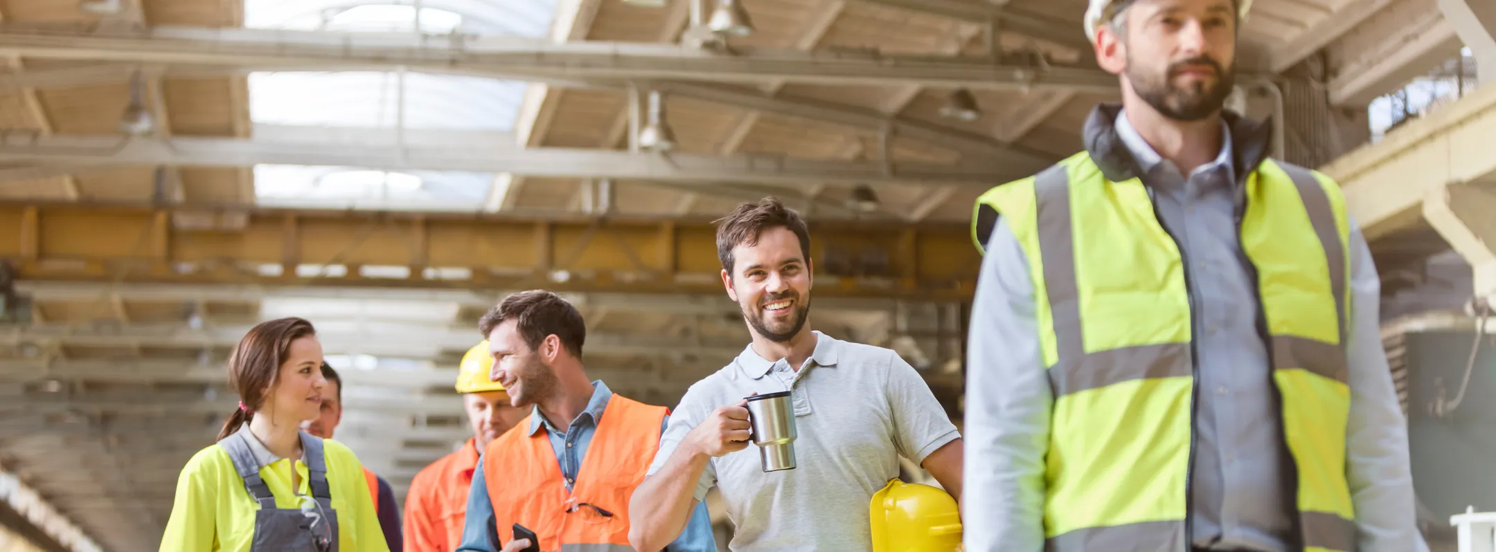 factory workers laughing and taking a break together in a factory with proper ventilation