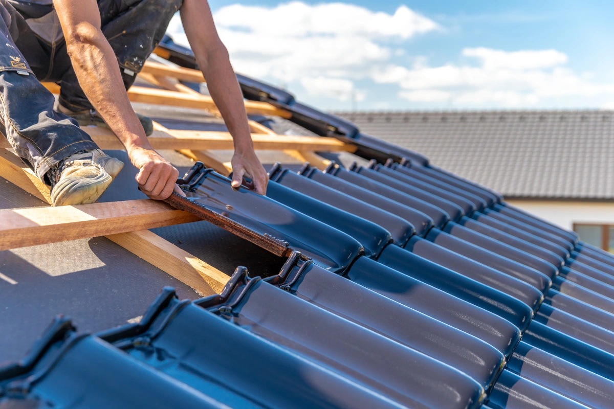 Closeup of roofing contractor installing roof in Conover, NC