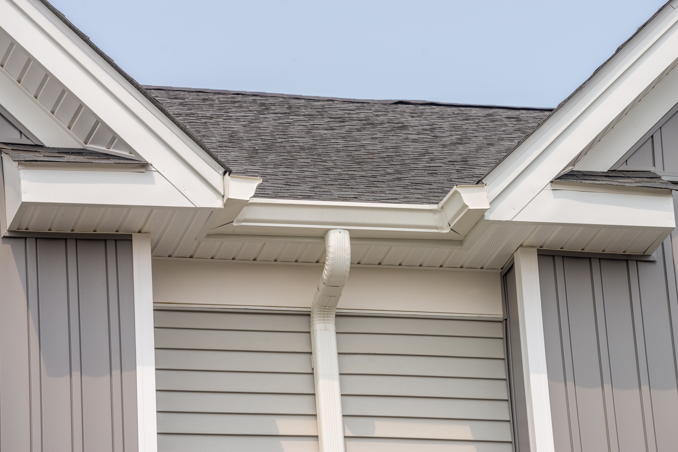 gutter with downpipe on the roof of a house metal pipe fasade roof water modern